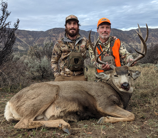 My son and I with a very respectable Colorado mule deer buck symmetrical 4 point mule deer buck