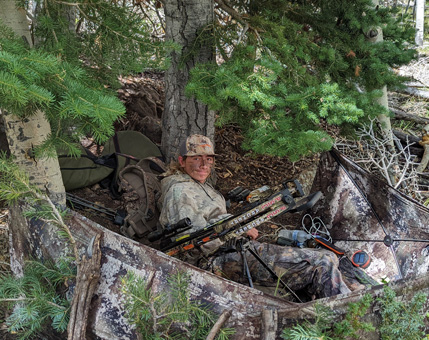 Setup in his blind with bipod mounted on crossbow ground blind with crossbow archery hunting