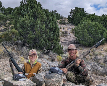 Boys with a couple birds, sitting next to mine shaft i went hunting pigeon hunting
