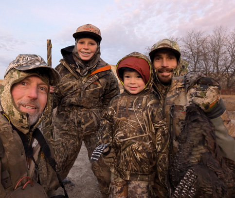 Group pic with Cooper and his souvenir turkey feather! bobcat attacked just before this picture