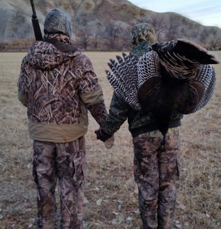 With her trophy fall turkey heading back to camp