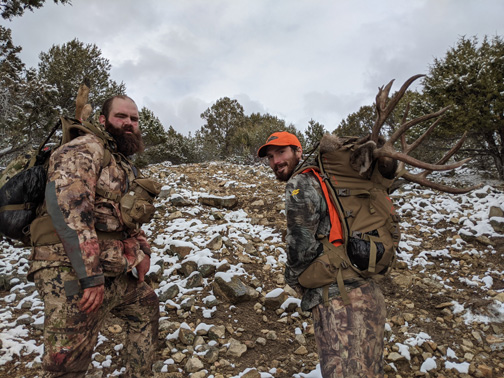 Mark and Dallas heading back up the mountain with our buck quartered deer and backpacking out