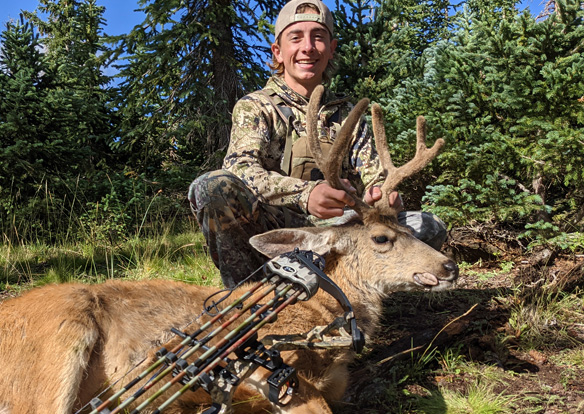 Opening morning, Carson couldn't be more excited with his archery buck! three point mule deer buck archery